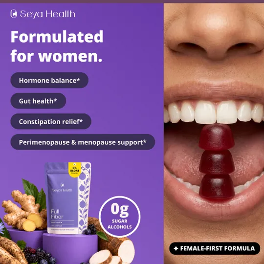 Formulated for women: four benefit pills beside a gummy held between teeth